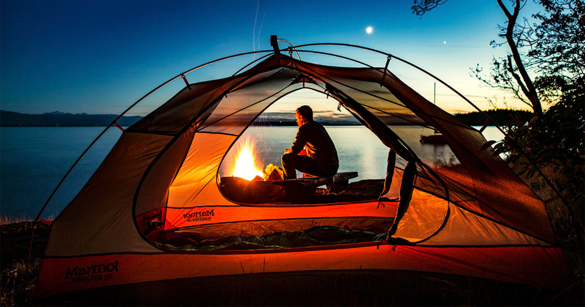eric at a campfire in new zealand using a marmot tent backpacking and hiking