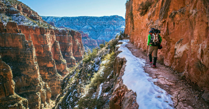 backpacker overlooking a canyon while backpacking and hiking what to bring on a multi day trip epic trails