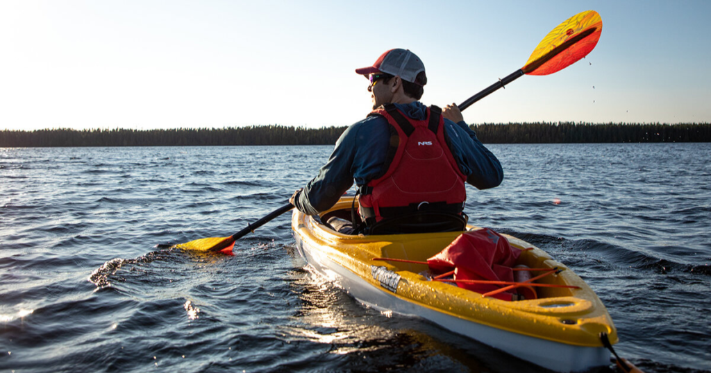 ken whiting using a sit inside kayak with an aquabound paddle on the water kayaking nrs