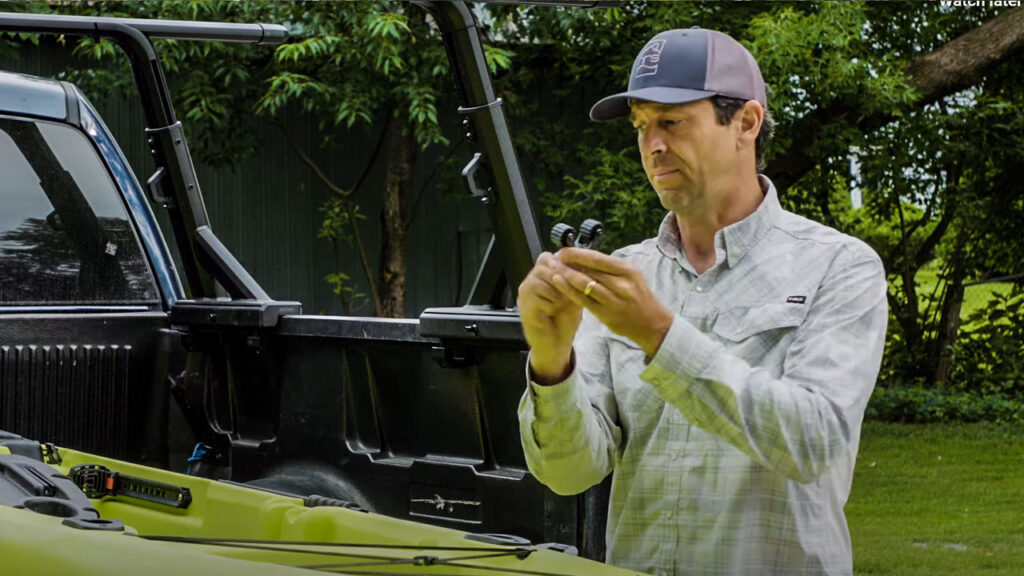 Paddle holder for a fishing kayak