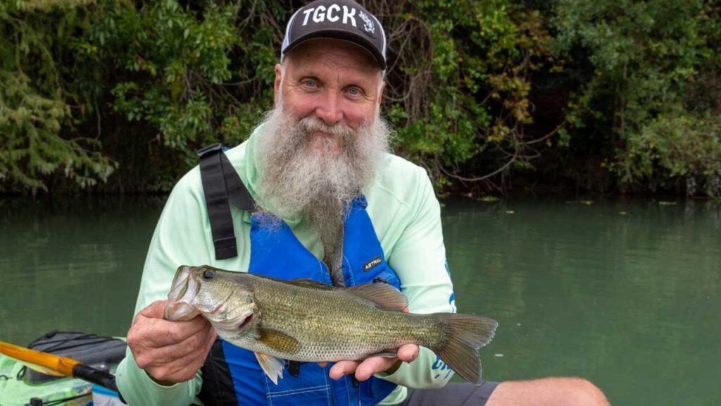 Dwayne holds up an awesome black bass while fishing the San Marcos River