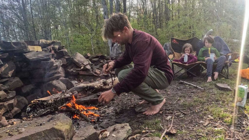 Nick hard at work getting a fire going. We do not take the "Davy Crockett" approach, we like our lighters