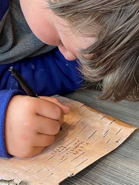 Tucker, the history buff, writing his homework out on birch bark! Whatever works!!!